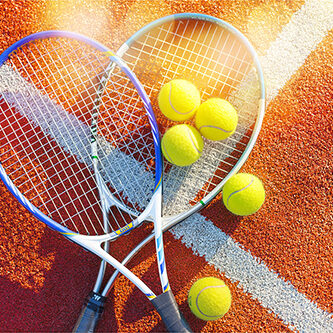 Tennis game. Tennis balls and rackets on  background.